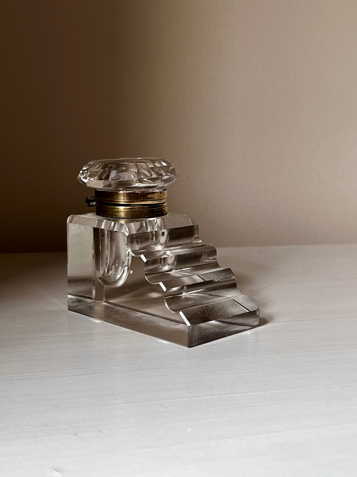 Art Deco crystal inkwell with stepped pen rest and brass-tone collar, c.1920s–3