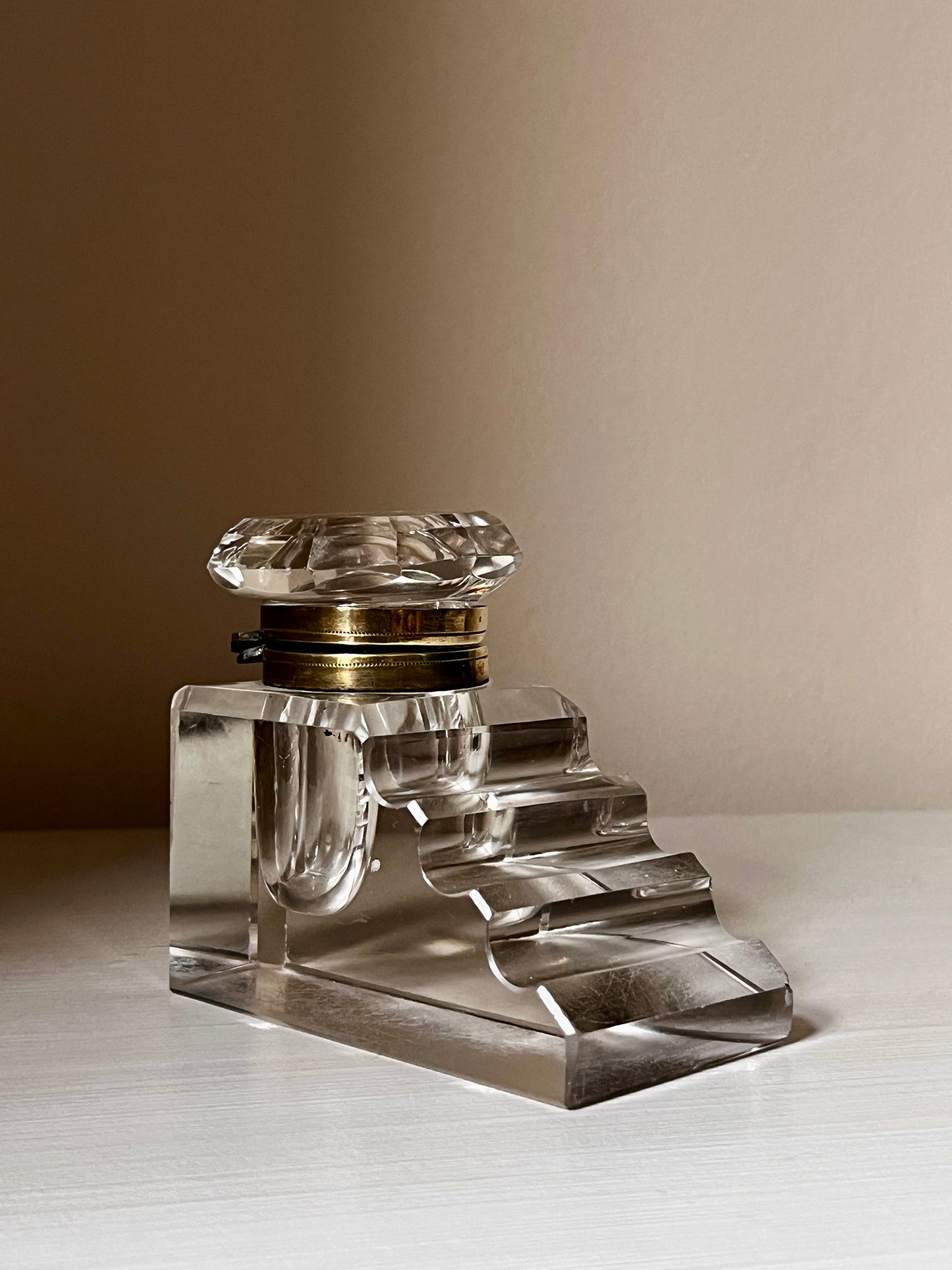 Art Deco crystal inkwell with stepped pen rest and brass-tone collar, c.1920s–3