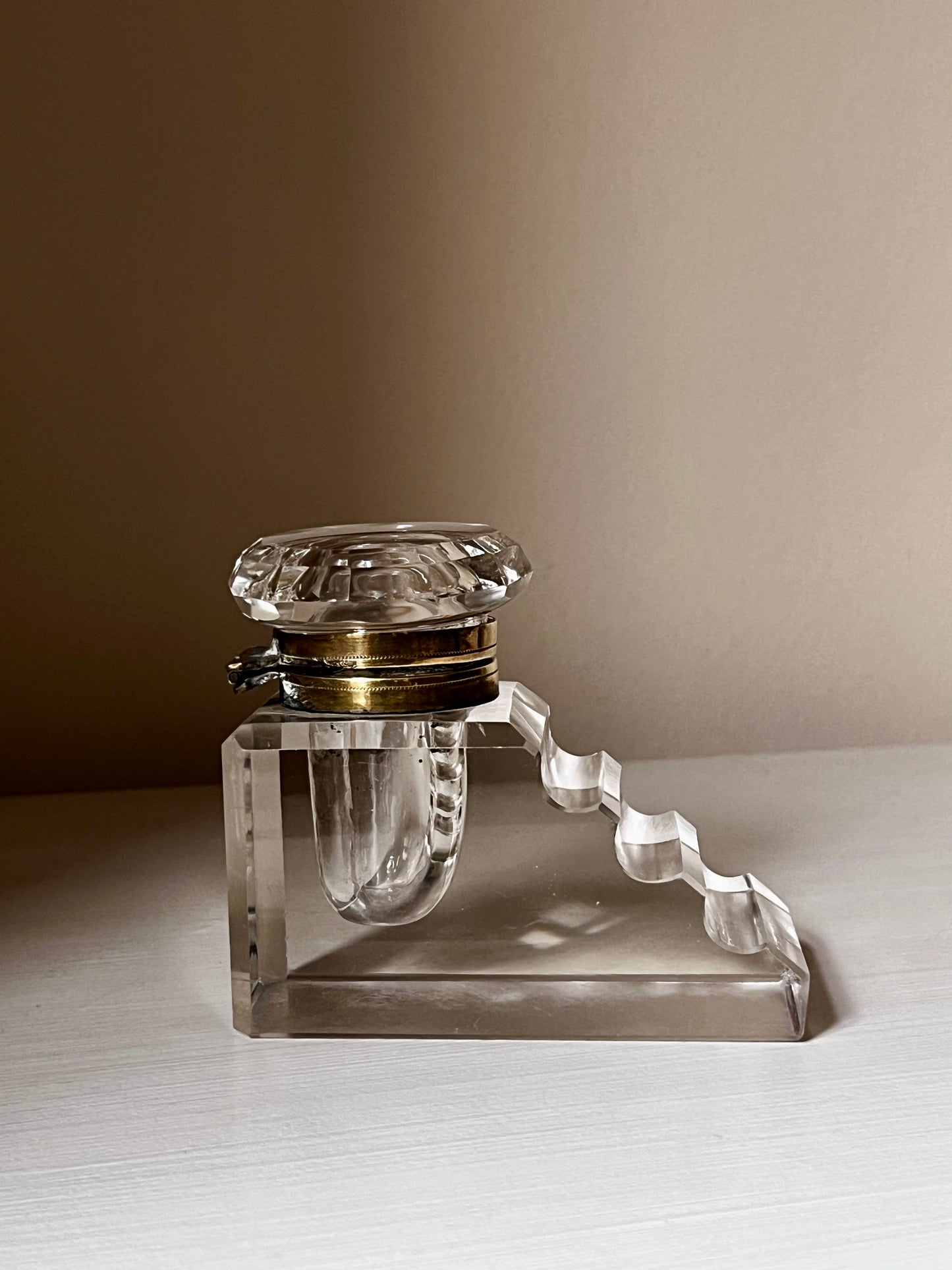 Art Deco crystal inkwell with stepped pen rest and brass-tone collar, c.1920s–3