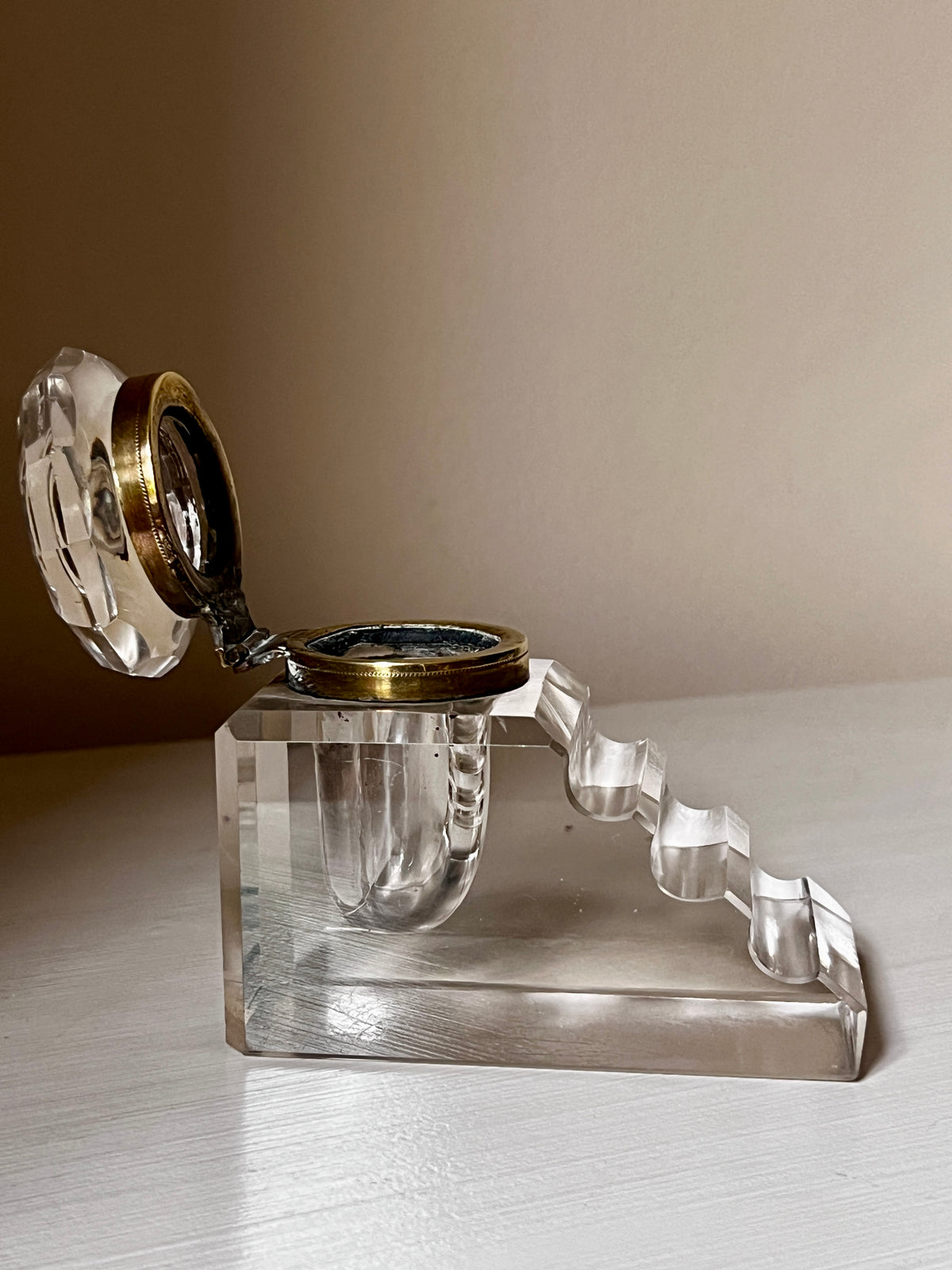 Art Deco crystal inkwell with stepped pen rest and brass-tone collar, c.1920s–3